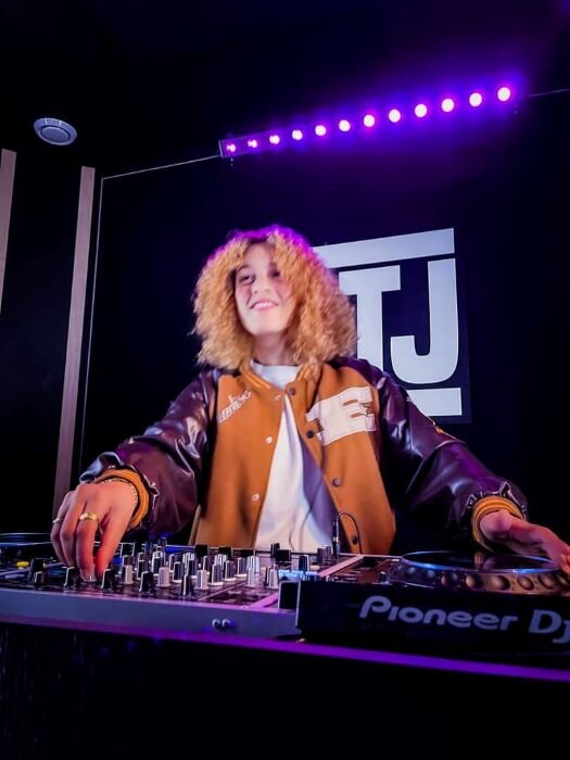 Smiling woman DJing on CDJ-3000s