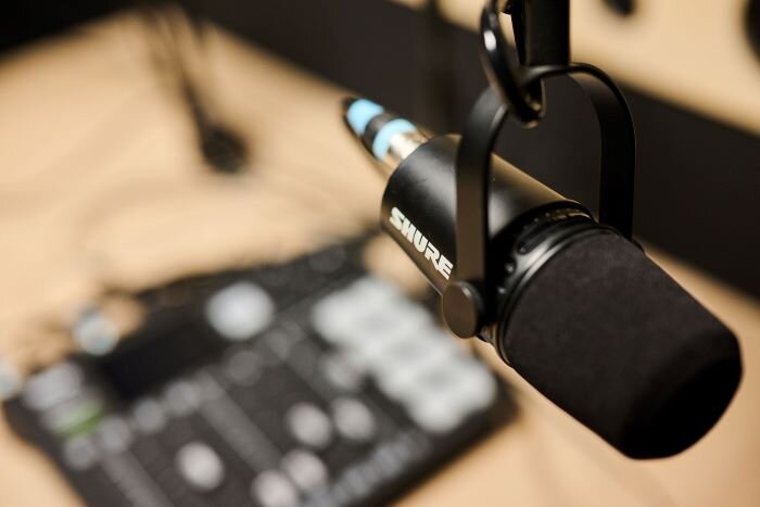 Shure MV7 microphone in podcast studio with Rodecaster Pro console