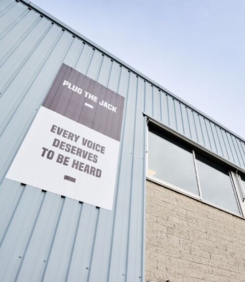 Facade of the Plug The Jack building in Brussels, inscribed with the phrase 'Every voice deserves to be heard