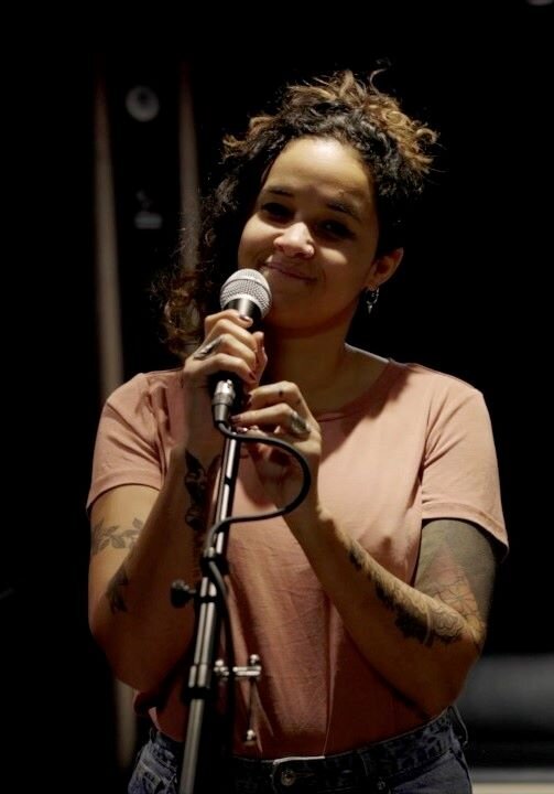 Female singer holding a microphone in a rehearsal room in Brussels 