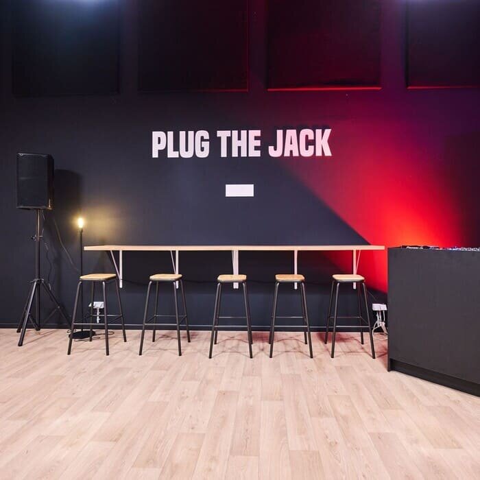 Lobby with high table and high chairs at Plug The Jack