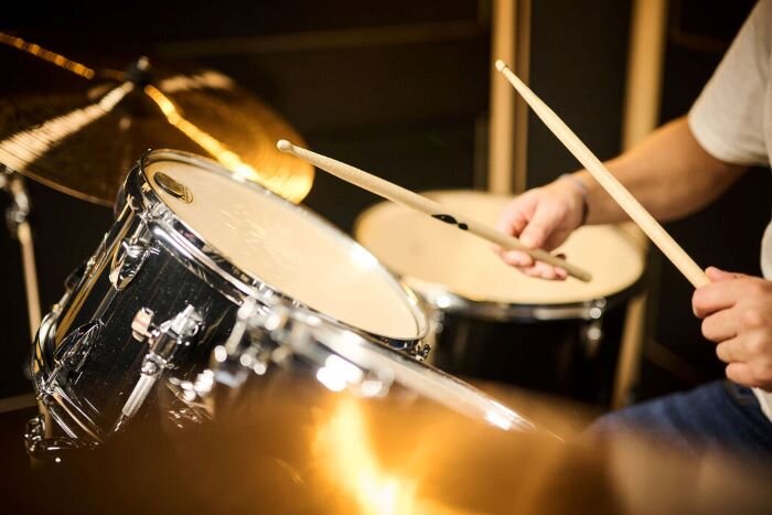 Drummer in front of his Tama Imperial Star drum kit in a rehearsal studio